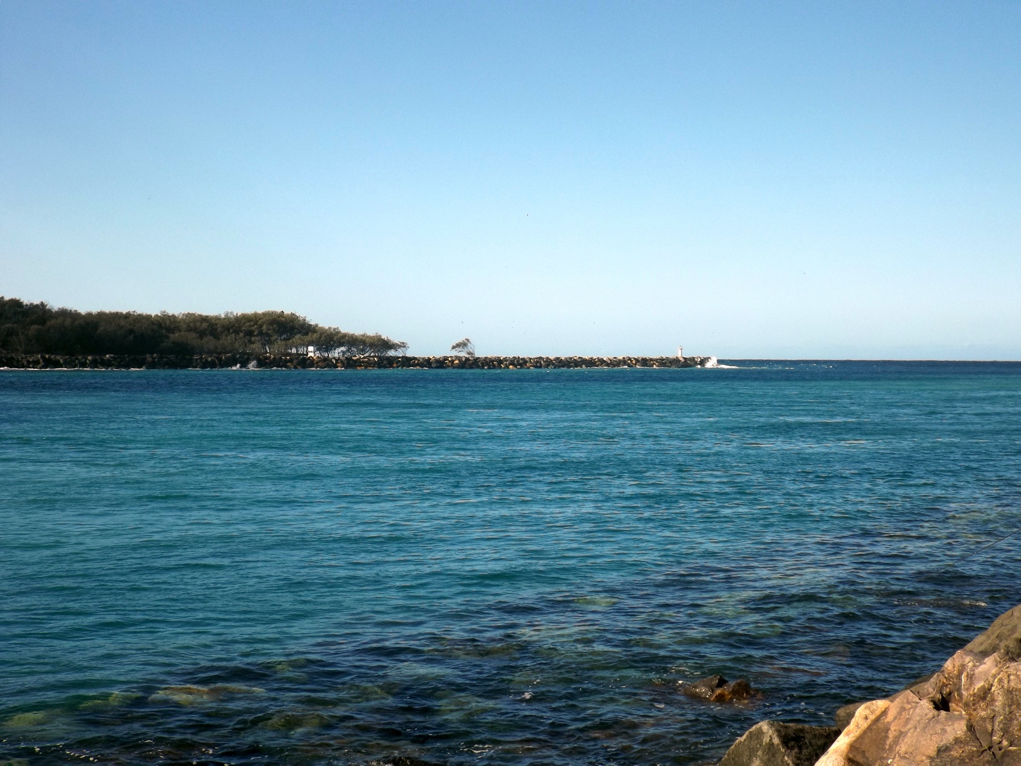 The Southport Seaway rock wall and the tip of the Spit across the calm Broadwater, Gold Coast